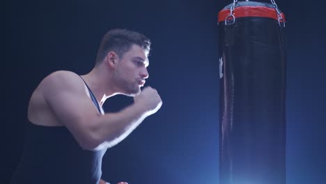 Male-boxer.-Strong-athlete-hits-the-punching-bag.